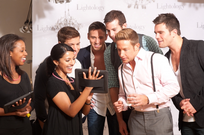 trade show models show guests how to email photos to social media with iPad