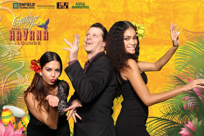 trade show models dance with guest at green screen photobooth havana cuba themed event
