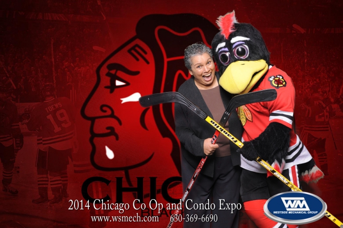 blackhawk mascot tommy hawk poses with fan at green screen tradeshow photobooth, navy pier, chicago co op and condo expo